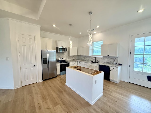 32 Foxchase Dr, Mason, TN 38049 - kitchen featuring appliances with stainless steel finishes, ornamental molding, tasteful backsplash, light wood-type flooring, and white cabinetry