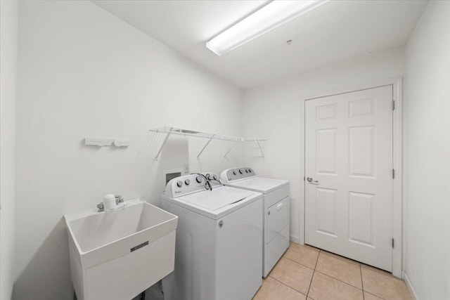 8897 Parkview Oaks Cir, Olive Branch, MS 38654 - washroom featuring separate washer and dryer and light tile patterned floors