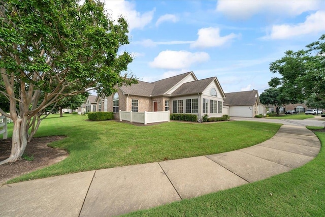 8897 Parkview Oaks Cir, Olive Branch, MS 38654 - view of front of property with brick siding, a front yard, a garage, and driveway
