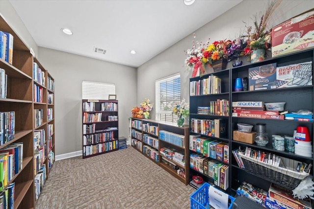 8897 Parkview Oaks Cir, Olive Branch, MS 38654 - miscellaneous room with wall of books, recessed lighting, and carpet