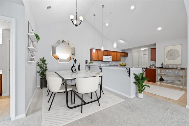 8897 Parkview Oaks Cir, Olive Branch, MS 38654 - dining space featuring high vaulted ceiling, a chandelier, light carpet, and recessed lighting