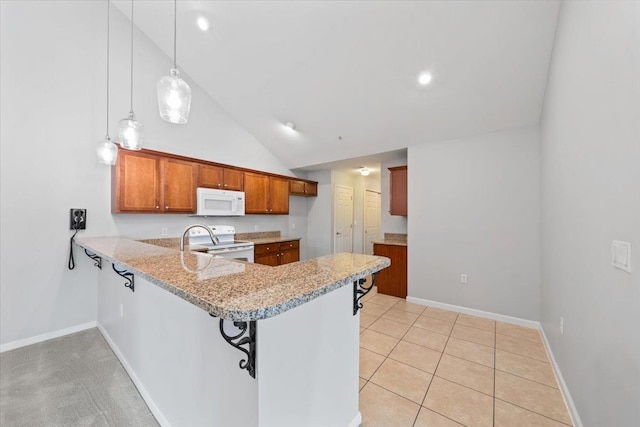 8897 Parkview Oaks Cir, Olive Branch, MS 38654 - kitchen with white appliances, a peninsula, brown cabinets, light stone countertops, and decorative light fixtures
