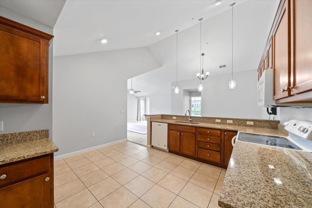 8897 Parkview Oaks Cir, Olive Branch, MS 38654 - kitchen featuring white appliances, lofted ceiling, a peninsula, hanging light fixtures, and brown cabinetry
