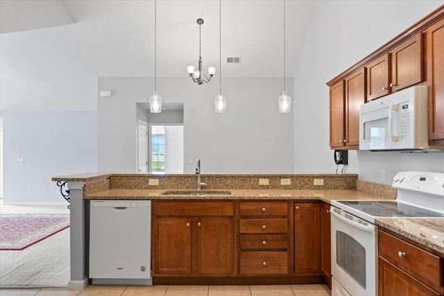 8897 Parkview Oaks Cir, Olive Branch, MS 38654 - kitchen featuring white appliances, light stone counters, brown cabinets, a peninsula, and pendant lighting