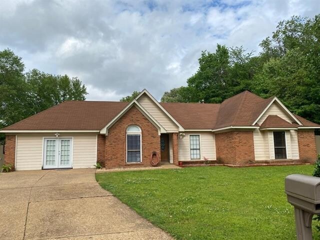 7148 Tranquil Creek Dr, Memphis, TN 38125 - view of front of property with french doors, brick siding, and a front lawn