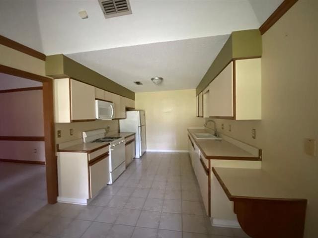 7148 Tranquil Creek Dr, Memphis, TN 38125 - kitchen with white appliances, white cabinetry, light tile patterned flooring, and light countertops