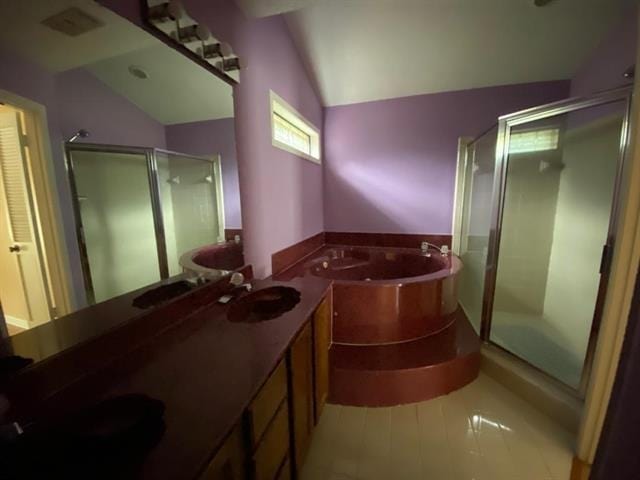 7148 Tranquil Creek Dr, Memphis, TN 38125 - bathroom featuring a shower stall, a garden tub, vaulted ceiling, and double vanity