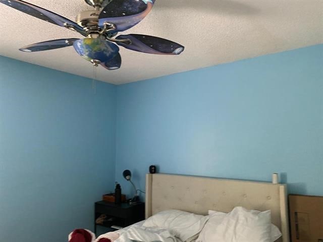 7148 Tranquil Creek Dr, Memphis, TN 38125 - bedroom with a textured ceiling and a ceiling fan