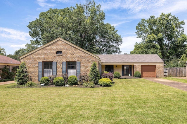 5662 Chapman Ave, Memphis, TN 38119 - view of front of house featuring brick siding, a garage, concrete driveway, and a front yard