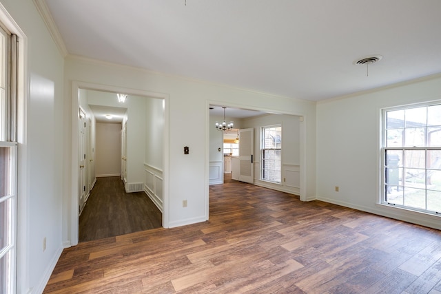 5662 Chapman Ave, Memphis, TN 38119 - unfurnished room with wood finished floors, a chandelier, crown molding, and plenty of natural light