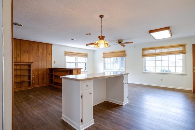 5662 Chapman Ave, Memphis, TN 38119 - kitchen featuring dark wood-style floors, healthy amount of natural light, white cabinets, and a ceiling fan