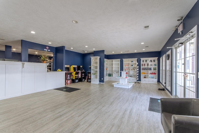 119 N 4th St, Selmer, TN 38375 - workout area with wood finished floors, a textured ceiling, and recessed lighting