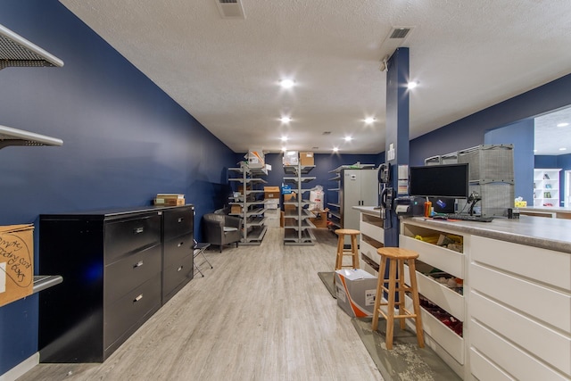 119 N 4th St, Selmer, TN 38375 - office area with light wood-type flooring and a textured ceiling