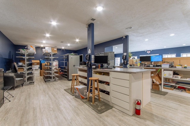 119 N 4th St, Selmer, TN 38375 - misc room with light wood finished floors, a textured ceiling, and recessed lighting