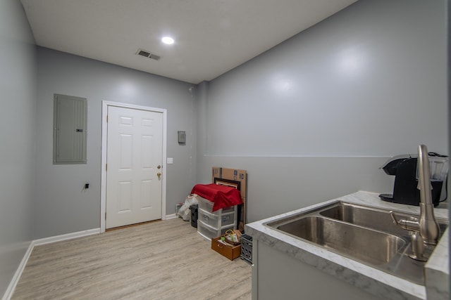 119 N 4th St, Selmer, TN 38375 - washroom featuring electric panel and light wood finished floors