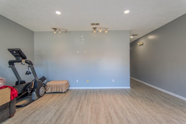 119 N 4th St, Selmer, TN 38375 - exercise area featuring wood finished floors, recessed lighting, and track lighting