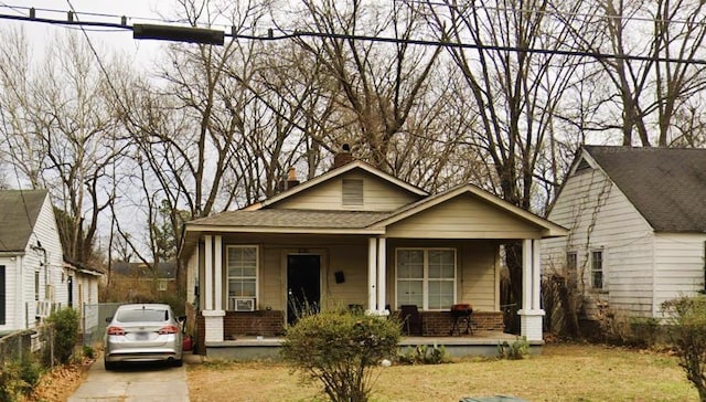 1014 N Dunlap St, Memphis, TN 38107 - bungalow-style home with a porch, brick siding, roof with shingles, a chimney, and a front lawn