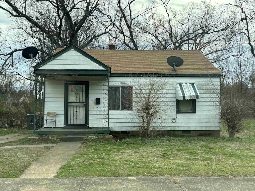 1983 Hubert Ave, Memphis, TN 38108 - view of front facade with a front yard and roof with shingles