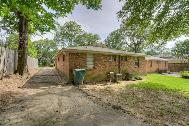 2092 Harbert Ave, Memphis, TN 38104 - back of house with brick siding, asphalt driveway, and a patio area