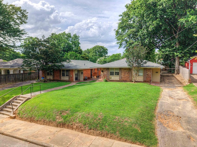 2092 Harbert Ave, Memphis, TN 38104 - ranch-style home featuring asphalt driveway, brick siding, and an outdoor structure