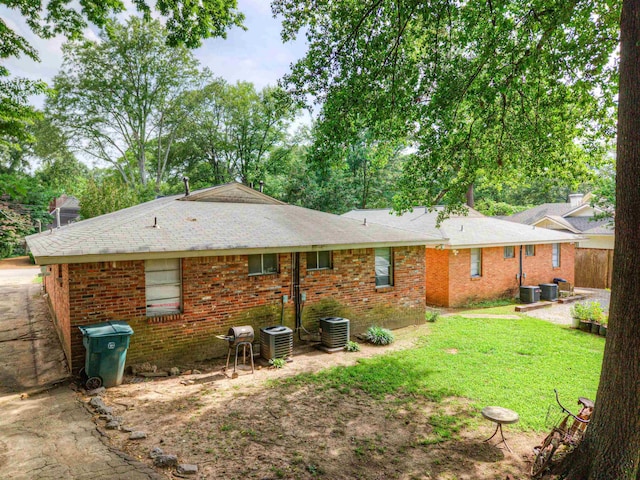 2092 Harbert Ave, Memphis, TN 38104 - back of house featuring brick siding, a lawn, a chimney, and roof with shingles