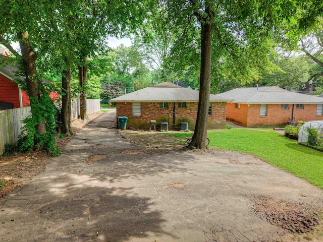 2092 Harbert Ave, Memphis, TN 38104 - back of house featuring brick siding and asphalt driveway