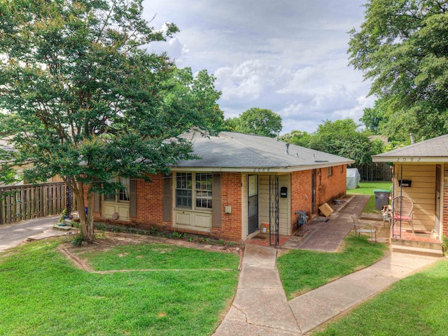 2086 Harbert Ave, Memphis, TN 38104 - view of front of house with brick siding, a patio area, and roof with shingles