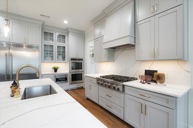 2486 E Allelon Rd E, Germantown, TN 38138 - kitchen with appliances with stainless steel finishes, custom range hood, tasteful backsplash, dark wood-type flooring, and glass insert cabinets