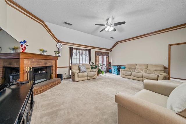 3889 Oak Trace Cv, Bartlett, TN 38135 - carpeted living room featuring a fireplace, vaulted ceiling, ornamental molding, a ceiling fan, and a textured ceiling