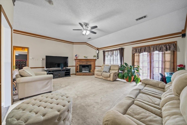3889 Oak Trace Cv, Bartlett, TN 38135 - carpeted living area featuring a ceiling fan, lofted ceiling, crown molding, a textured ceiling, and a fireplace