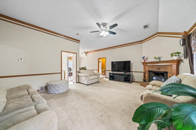 3889 Oak Trace Cv, Bartlett, TN 38135 - carpeted living room with ceiling fan, crown molding, lofted ceiling, a textured ceiling, and a fireplace