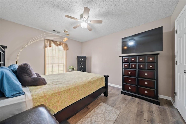 3889 Oak Trace Cv, Bartlett, TN 38135 - bedroom featuring wood finished floors, a textured ceiling, and ceiling fan