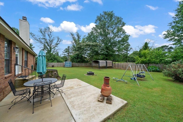 3889 Oak Trace Cv, Bartlett, TN 38135 - fenced backyard featuring a storage unit, a patio, and outdoor dining space