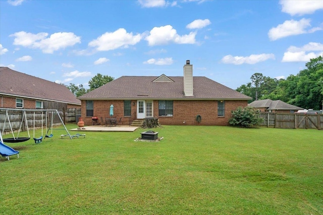 3889 Oak Trace Cv, Bartlett, TN 38135 - back of property featuring a patio area, a playground, a chimney, brick siding, and a fenced backyard