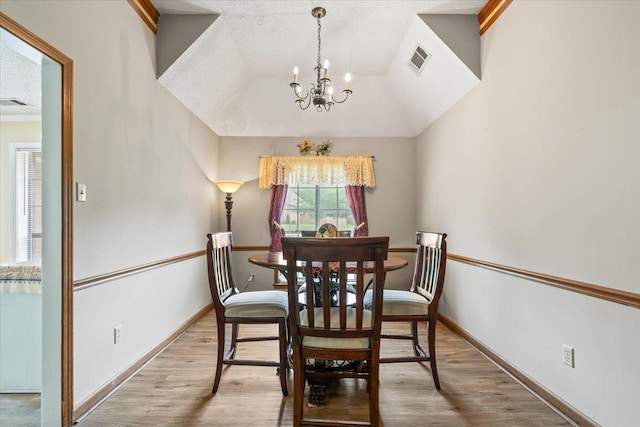 3889 Oak Trace Cv, Bartlett, TN 38135 - dining space with a chandelier, light wood finished floors, and a textured ceiling