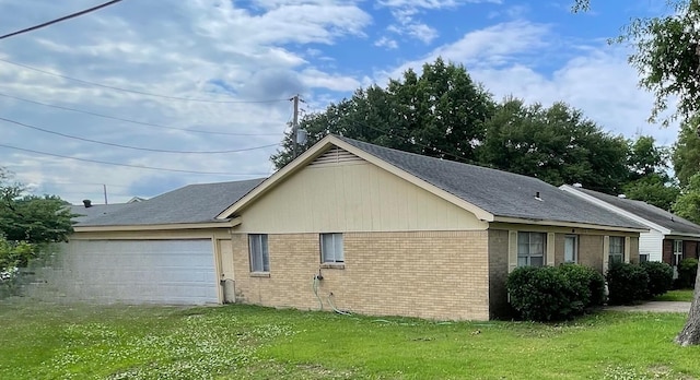 83 Henry St, Marion, AR 72364 - view of property exterior with brick siding, a yard, an attached garage, driveway, and a shingled roof