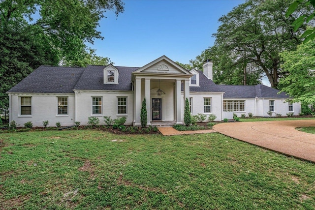 4234 Poplar Ave, Memphis, TN 38117 - greek revival inspired property featuring a front lawn, a chimney, and roof with shingles