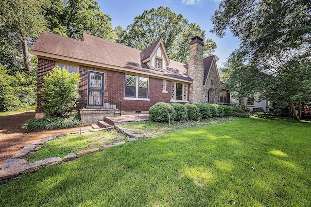 2067 Hallwood Dr, Memphis, TN 38107 - view of front facade with a front yard, brick siding, and a chimney