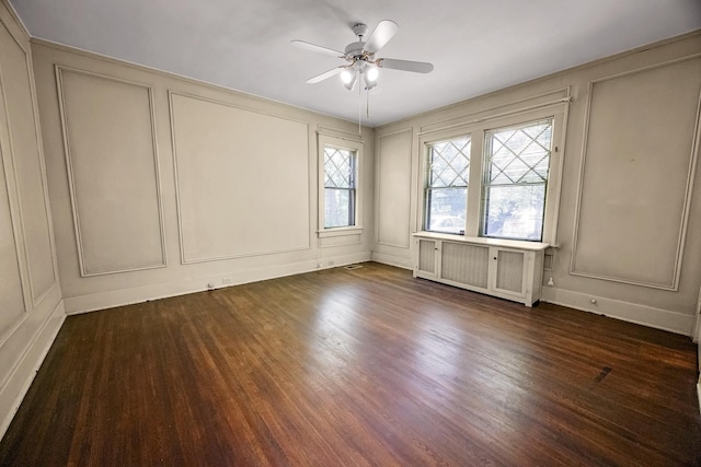 2067 Hallwood Dr, Memphis, TN 38107 - empty room with a decorative wall, ceiling fan, and dark wood finished floors