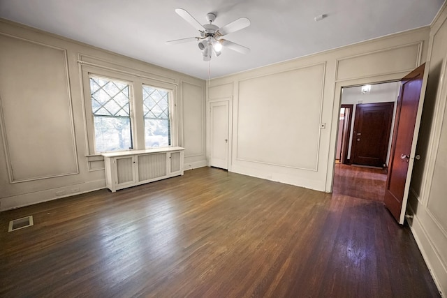 2067 Hallwood Dr, Memphis, TN 38107 - unfurnished bedroom with a decorative wall, dark wood-style floors, and ceiling fan