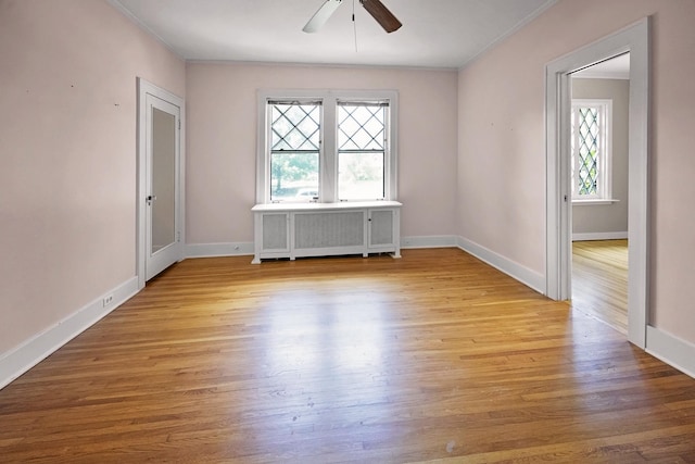 2067 Hallwood Dr, Memphis, TN 38107 - unfurnished room featuring ornamental molding, ceiling fan, radiator heating unit, and wood finished floors