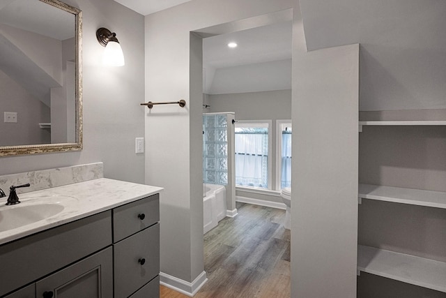 2067 Hallwood Dr, Memphis, TN 38107 - bathroom featuring vanity, wood finished floors, and tub / shower combination