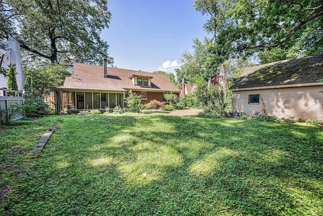2067 Hallwood Dr, Memphis, TN 38107 - rear view of property featuring a sunroom and a yard