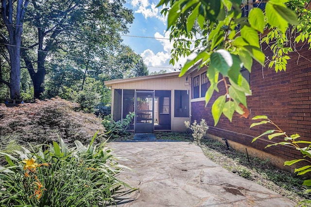 2067 Hallwood Dr, Memphis, TN 38107 - doorway to property featuring a patio and brick siding