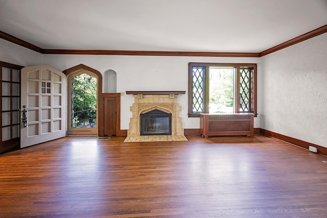 2067 Hallwood Dr, Memphis, TN 38107 - unfurnished living room featuring ornamental molding, wood finished floors, a textured wall, a fireplace with flush hearth, and radiator heating unit