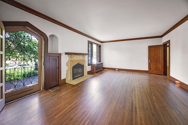2067 Hallwood Dr, Memphis, TN 38107 - unfurnished living room with wood finished floors, a fireplace with flush hearth, ornamental molding, and arched walkways