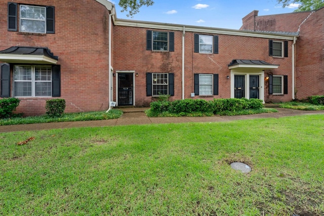 5686 Quince Rd Unit 3, Memphis, TN 38119 - townhome / multi-family property with a front yard, a chimney, and brick siding