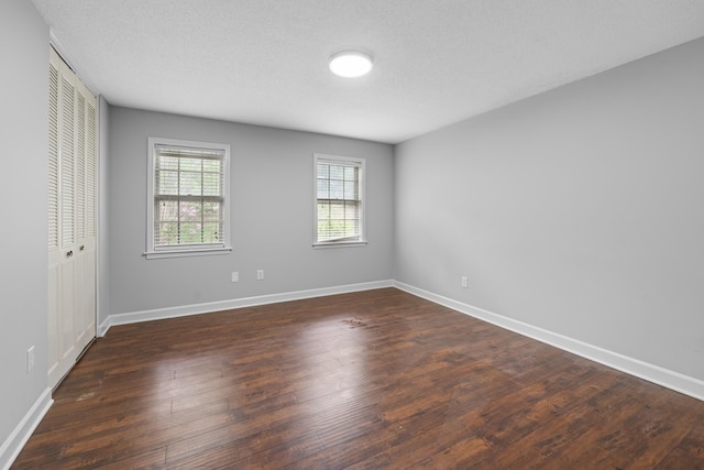 5686 Quince Rd Unit 3, Memphis, TN 38119 - unfurnished bedroom with a closet, dark wood-style flooring, and a textured ceiling