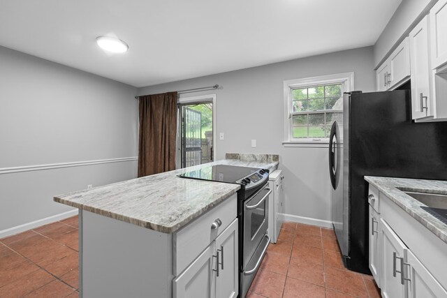 5686 Quince Rd Unit 3, Memphis, TN 38119 - kitchen featuring appliances with stainless steel finishes, a peninsula, tile patterned floors, and white cabinets