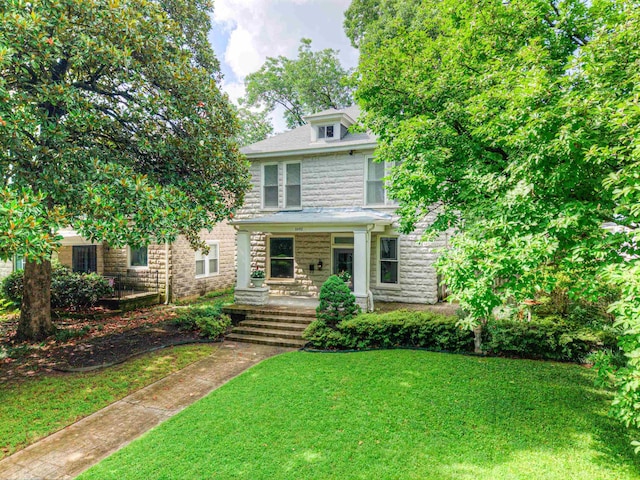 1692 Carruthers Pl, Memphis, TN 38112 - american foursquare style home featuring a front yard, stone siding, and a porch